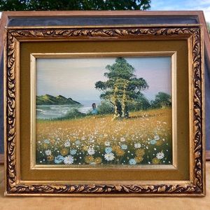 Vintage painting in golden frame : little girl flower field ocean mountain trees